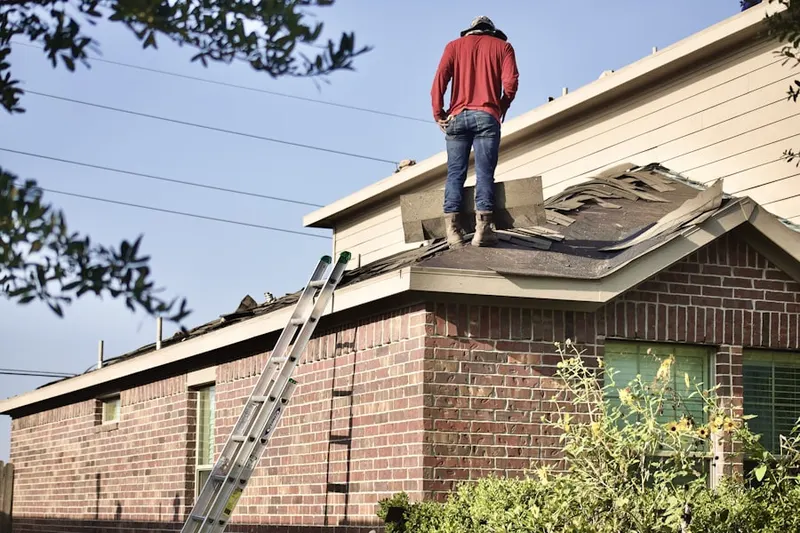Professional roofer working on a residential roof in Far West Side